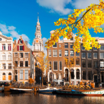 Facades of old historic Houses over canal water, Amsterdam, Netherlands at fall